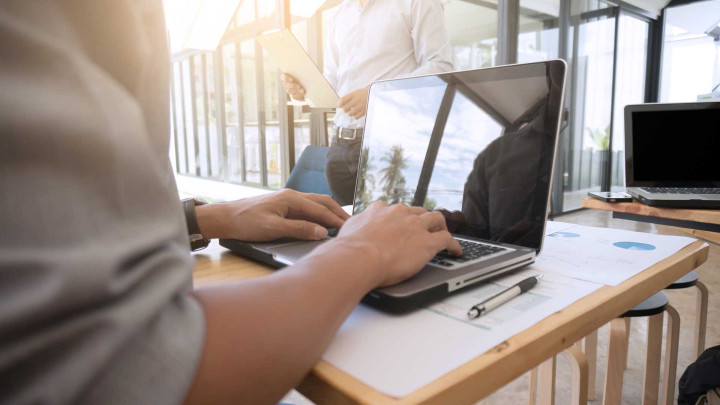 Person typing on laptop at desk